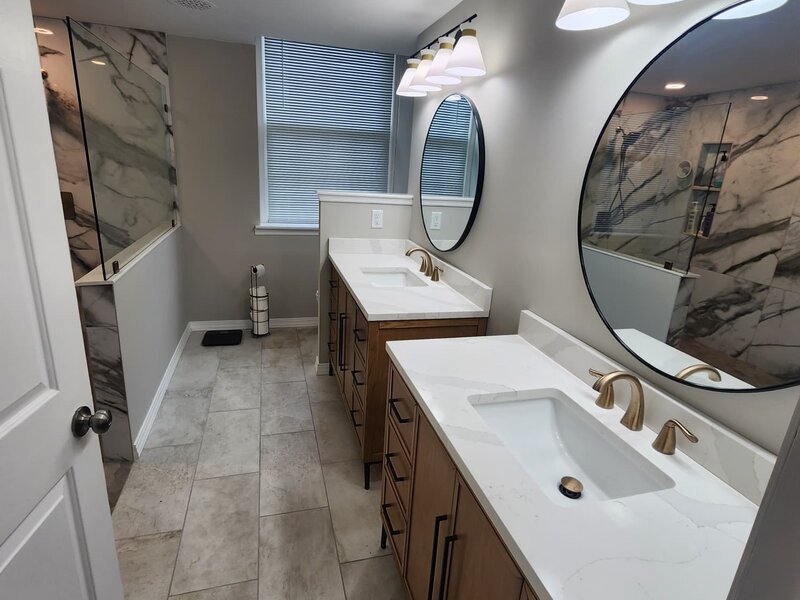 Bathroom remodel with tile floor and double vanity by JN Contractor LLC