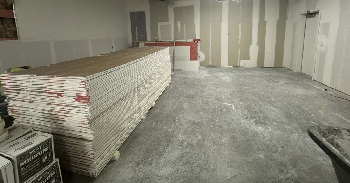 Drywall sheets stacked and ready for installation on commercial job site