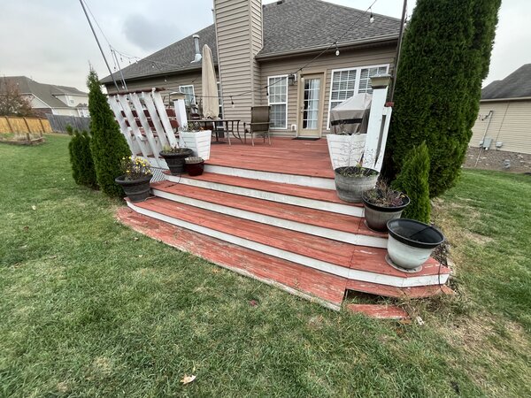 Old red stained deck before renovation in Nashville TN